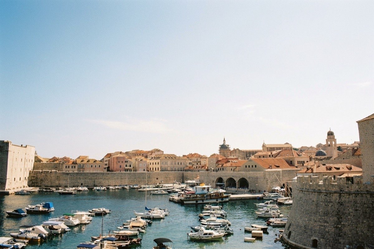 Boats in Dubrovnik's old harbour beneath the city walls