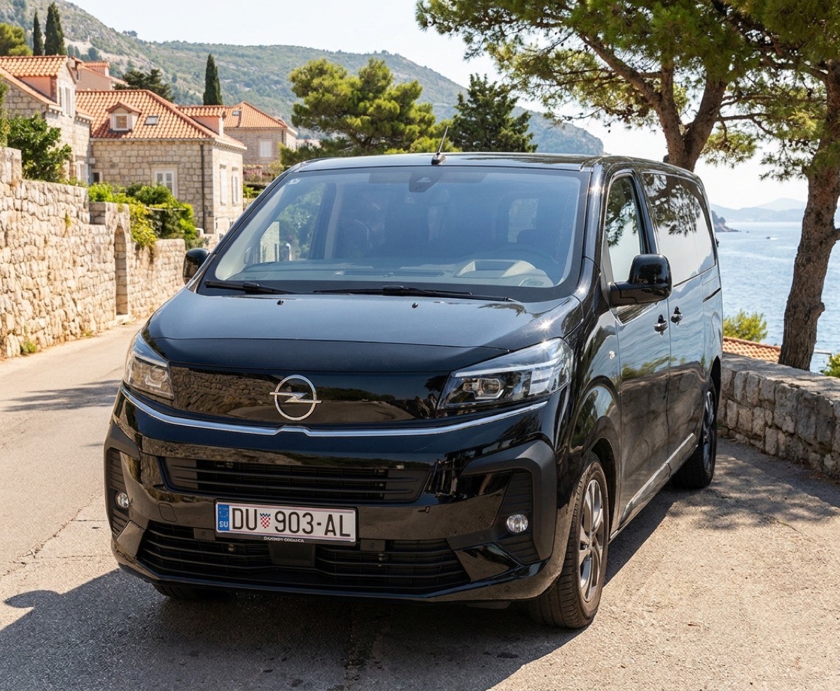 Black Opel Vivaro passenger van on a Dubrovnik coast road